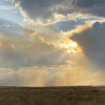 Image of the sun peaking through clouds in Casper WY